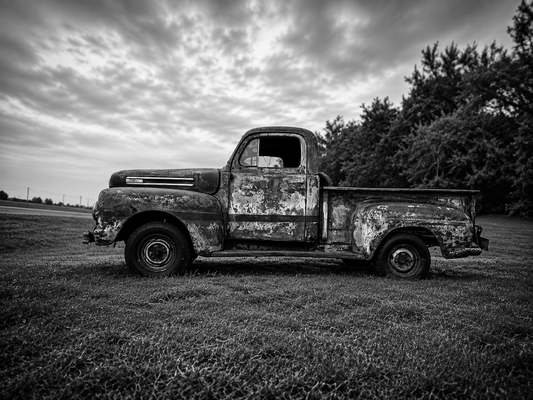 Bring the quiet beauty of rural America into your home with this striking black and white photograph of a weathered vintage farm truck resting beneath dramatic Texas skies. Rich in texture, history, and character, this fine art print celebrates the enduri